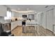 Bright updated kitchen with stainless steel appliances, white cabinets, granite countertops, and stylish mosaic backsplash at 719 58Th S St, Gulfport, FL 33707