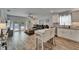 Open-concept living space featuring an eat-in kitchen, a large sectional couch, and sliding doors that lead to the pool at 719 58Th S St, Gulfport, FL 33707
