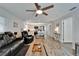 Open living space with modern kitchen and seating, featuring wood-look floors and stainless appliances at 719 58Th S St, Gulfport, FL 33707