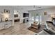 Open-concept living space with wood-look flooring, a view of the back yard pool, and a view into the main bedroom at 719 58Th S St, Gulfport, FL 33707