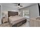 Main bedroom with a large headboard, dresser and gray colored wood look flooring at 719 58Th S St, Gulfport, FL 33707