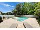 Inviting backyard pool and patio area, features travertine tile, manicured landscaping, and comfortable seating areas at 719 58Th S St, Gulfport, FL 33707