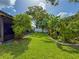 Spacious backyard with green grass and privacy landscaping; perfect for relaxation and outdoor activities at 7444 119Th Ave, Largo, FL 33773