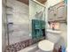 Updated bathroom features a shower with gray tiles, glass doors, and a grey cabinet at 7444 119Th Ave, Largo, FL 33773