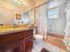 Full bathroom with a vanity, sink, toilet, bathtub, and shower with themed shower curtain at 7444 119Th Ave, Largo, FL 33773
