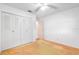 Bright bedroom features a ceiling fan, neutral carpet, and large closet with doors at 7444 119Th Ave, Largo, FL 33773