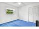 Bright bedroom features a large window with white trim and a double door closet at 7444 119Th Ave, Largo, FL 33773