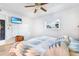 Cozy bedroom with wood floors, a ceiling fan, a television, a window, and neutral-colored walls at 7444 119Th Ave, Largo, FL 33773