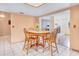 Open dining area with a round table, tile floor, and a clear view into the adjacent living room and fireplace at 7444 119Th Ave, Largo, FL 33773