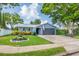Charming single-story home featuring a well-manicured lawn, mature trees, and inviting curb appeal at 7444 119Th Ave, Largo, FL 33773