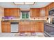 Bright kitchen displays light wood cabinets, granite countertops, stainless steel appliances, and tile flooring at 7444 119Th Ave, Largo, FL 33773