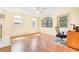 Bright, airy room with several windows letting in natural light, a ceiling fan, and clean laminate floors at 7444 119Th Ave, Largo, FL 33773