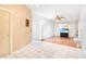 Open-concept living room with tile flooring, a Tiffany style floor lamp, and views to main living area at 7444 119Th Ave, Largo, FL 33773