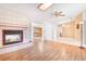 Open-concept living room with a cozy fireplace, ceiling fan, and skylight with views to dining room at 7444 119Th Ave, Largo, FL 33773