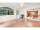 Bright living room featuring wood floors, a ceiling fan, and a view of the connected kitchen and dining area at 7444 119Th Ave, Largo, FL 33773