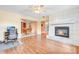 Open-concept living room with tile fireplace, ceiling fan, and views to kitchen and adjacent room at 7444 119Th Ave, Largo, FL 33773