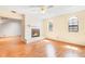 Living room featuring tile fireplace, ceiling fan, hardwood floors, and views to adjacent room at 7444 119Th Ave, Largo, FL 33773