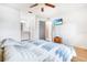 Large main bedroom with wood floors, an ensuite bathroom, a ceiling fan, and a wall-mounted television at 7444 119Th Ave, Largo, FL 33773