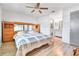 Spacious main bedroom with wood floors, a ceiling fan, and an ensuite bathroom with vanity and shower at 7444 119Th Ave, Largo, FL 33773