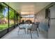 Enclosed patio area with dining table, chairs, concrete flooring, and views of the backyard at 7444 119Th Ave, Largo, FL 33773