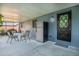 Enclosed patio area with dining table, chairs, and a refrigerator for outdoor dining at 7444 119Th Ave, Largo, FL 33773