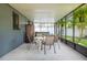 Bright sunroom has views of the greenery and includes a hot tub, chairs, and table at 7444 119Th Ave, Largo, FL 33773