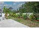 Lush backyard with a privacy fence and tropical landscaping offering a serene outdoor setting and secluded retreat at 7503 Winchester Dr, Tampa, FL 33615
