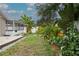 Backyard featuring tropical landscaping and a screened-in lanai at 7503 Winchester Dr, Tampa, FL 33615