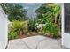 An inviting backyard featuring a lovely garden, lush greenery, and privacy fence creating a tranquil outdoor retreat at 7503 Winchester Dr, Tampa, FL 33615