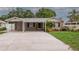 Charming single-story home with well-maintained lawn, mature landscaping, and covered parking at 7503 Winchester Dr, Tampa, FL 33615