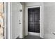 Front entrance featuring black door with stone accents and security features at 7503 Winchester Dr, Tampa, FL 33615