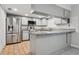 Updated kitchen featuring stainless steel appliances, granite countertops, and ample cabinet space at 7503 Winchester Dr, Tampa, FL 33615