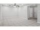 Spacious living area with tile flooring, ceiling fan, and neutral color palette at 7503 Winchester Dr, Tampa, FL 33615