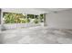 Enclosed patio featuring tile flooring, white brick wall, and views of lush greenery at 7503 Winchester Dr, Tampa, FL 33615
