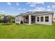 A lovely backyard featuring an outdoor seating area, grill, swing set, and lush green grass at 7616 Paradiso Dr, Apollo Beach, FL 33572