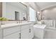 Bright bathroom showcasing double vanity with framed mirrors and a large soaking tub at 7616 Paradiso Dr, Apollo Beach, FL 33572