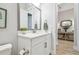 Bright bathroom with a white vanity, quartz countertop, modern fixtures, and an elegant framed mirror at 7616 Paradiso Dr, Apollo Beach, FL 33572