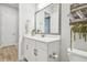 Bright bathroom featuring a white vanity, large mirror, decor and gray-tone flooring at 7616 Paradiso Dr, Apollo Beach, FL 33572