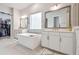 Elegant bathroom features a soaking tub, double vanity, and a walk-in closet for ample storage at 7616 Paradiso Dr, Apollo Beach, FL 33572