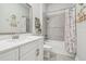 Bright bathroom featuring a white vanity, stylish decor and a shower-tub combination with elegant tiling at 7616 Paradiso Dr, Apollo Beach, FL 33572