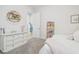 Bright bedroom features a white dresser, round shelf, and a shelf of books at 7616 Paradiso Dr, Apollo Beach, FL 33572
