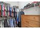 Organized walk-in closet with clothing racks, shelves, and a dresser for maximum storage efficiency at 7616 Paradiso Dr, Apollo Beach, FL 33572