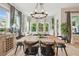 Dining room featuring modern chandelier, hardwood floors and lots of natural light from surrounding windows at 7616 Paradiso Dr, Apollo Beach, FL 33572