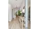 Inviting entryway with a wooden console table, decorative lamps, mirror and hardwood flooring at 7616 Paradiso Dr, Apollo Beach, FL 33572