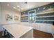Bright kitchen with white cabinetry, stainless steel appliances, and geometric wallpaper at 7616 Paradiso Dr, Apollo Beach, FL 33572