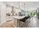 Modern kitchen featuring white cabinets, stainless steel appliances, tile backsplash and center island with bar seating at 7616 Paradiso Dr, Apollo Beach, FL 33572