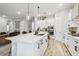 White kitchen features stainless steel appliances, subway tile backsplash and center island with barstool seating at 7616 Paradiso Dr, Apollo Beach, FL 33572