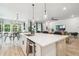 Bright kitchen with white cabinetry, stainless appliances, center island and opens to the dining and living area at 7616 Paradiso Dr, Apollo Beach, FL 33572