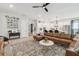 Open-concept living room flowing into kitchen with white cabinets and stainless steel appliances at 7616 Paradiso Dr, Apollo Beach, FL 33572