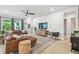 Living room featuring wood floors, shiplap accent wall, modern furniture and lots of natural light at 7616 Paradiso Dr, Apollo Beach, FL 33572